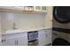 White laundry room cabinets and quartz countertop with a stackable washer and dryer at 9750 E Radioactive Dr, Mesa, AZ 85212