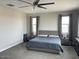 Spacious main bedroom with king bed, ceiling fan, and large windows at 9750 E Radioactive Dr, Mesa, AZ 85212