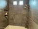 Modern shower with gray tile and built-in shelves at 9750 E Radioactive Dr, Mesa, AZ 85212