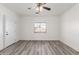 Spacious bedroom with wood-look floors and a ceiling fan at 9821 E University Dr, Mesa, AZ 85207