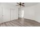 Bright bedroom with wood-look floors and double-door closet at 9821 E University Dr, Mesa, AZ 85207