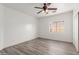 Bright bedroom with ceiling fan and window at 9821 E University Dr, Mesa, AZ 85207