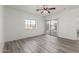 Bedroom featuring a window, sliding door and ceiling fan at 9821 E University Dr, Mesa, AZ 85207