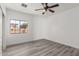 Bright bedroom with wood-look floors and a window at 9821 E University Dr, Mesa, AZ 85207