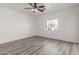 Bright bedroom with ceiling fan and wood-look flooring at 9821 E University Dr, Mesa, AZ 85207