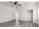 Spacious bedroom with wood-look floors and double-door closet at 9821 E University Dr, Mesa, AZ 85207