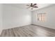 Spacious bedroom with wood-look floors and large window at 9821 E University Dr, Mesa, AZ 85207