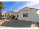 Modern home exterior, featuring a white stucco finish and palm tree at 9821 E University Dr, Mesa, AZ 85207