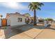 Newly remodeled home with a large driveway and a wood gate at 9821 E University Dr, Mesa, AZ 85207