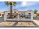 Remodeled home with a white exterior, landscaped front yard, and a new fence at 9821 E University Dr, Mesa, AZ 85207