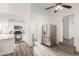 Contemporary kitchen featuring granite island, stainless steel fridge, and wood floors at 9821 E University Dr, Mesa, AZ 85207