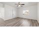 Bright and airy living room featuring wood-look flooring and ceiling fan at 9821 E University Dr, Mesa, AZ 85207