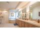 Elegant bathroom with double vanity and a large tub at 9825 E Sharon Dr, Scottsdale, AZ 85260