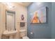 Small half bathroom with pedestal sink and toilet at 9825 E Sharon Dr, Scottsdale, AZ 85260