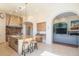 Open kitchen with an island and a view into the living area at 9825 E Sharon Dr, Scottsdale, AZ 85260