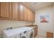 Laundry room with washer, dryer, and cabinets at 9825 E Sharon Dr, Scottsdale, AZ 85260