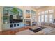 Bright living room with built-in shelving and a fireplace at 9825 E Sharon Dr, Scottsdale, AZ 85260