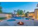 Resort-style backyard oasis with a pool, spa, and fire pit at 9825 E Sharon Dr, Scottsdale, AZ 85260