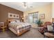 Guest bedroom with wood bed frame and window seat at 9945 E Prospector Dr, Gold Canyon, AZ 85118