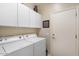 Bright laundry room with washer, dryer, and ample storage at 9945 E Prospector Dr, Gold Canyon, AZ 85118