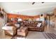 Relaxing living room with a leather couch and ottoman at 9945 E Prospector Dr, Gold Canyon, AZ 85118