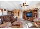 Spacious living room featuring a leather sofa and large entertainment center at 9945 E Prospector Dr, Gold Canyon, AZ 85118