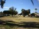 Community view showing homes and mature landscaping at 10731 W Mission Ln, Sun City, AZ 85351