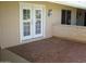 Charming back porch with double doors to the home and unique textured concrete at 10731 W Mission Ln, Sun City, AZ 85351