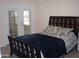 Bedroom showcasing a bed, French doors, and neutral-colored walls at 10731 W Mission Ln, Sun City, AZ 85351