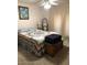 Cozy bedroom features a comfortable bed, warm lighting, and decorative mirror at 10731 W Mission Ln, Sun City, AZ 85351