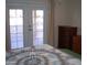 Bedroom with a bed and dresser, access to patio at 10731 W Mission Ln, Sun City, AZ 85351