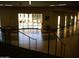 Indoor hallway overlooking a resort-style pool and seating area at 10731 W Mission Ln, Sun City, AZ 85351