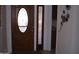 Entry door with glass sidelights and wood trim at 10731 W Mission Ln, Sun City, AZ 85351