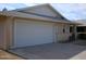 Tan house with white garage door and brick accents at 10731 W Mission Ln, Sun City, AZ 85351