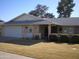 Tan single story home with attached garage and landscaped yard at 10731 W Mission Ln, Sun City, AZ 85351