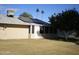 Rear view of home with screened patio and solar panels at 10731 W Mission Ln, Sun City, AZ 85351