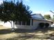 Tan single story home with screened patio and mature citrus tree at 10731 W Mission Ln, Sun City, AZ 85351