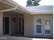 House exterior showcasing entryway with double doors and sliding glass door at 10731 W Mission Ln, Sun City, AZ 85351