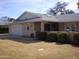 Beige house with a well-maintained lawn and landscaping at 10731 W Mission Ln, Sun City, AZ 85351