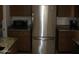 Kitchen features a stainless steel refrigerator and granite countertops at 10731 W Mission Ln, Sun City, AZ 85351