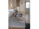 Close-up of kitchen with a granite countertop, stainless steel sink and tiled backsplash at 10731 W Mission Ln, Sun City, AZ 85351