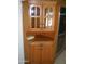 Corner cabinet with wooden framed glass doors and brass hardware at 10731 W Mission Ln, Sun City, AZ 85351