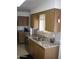 Kitchen showcasing stainless steel appliances, granite countertops, and a stylish tile backsplash at 10731 W Mission Ln, Sun City, AZ 85351