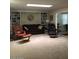 Carpeted living room with built-in shelves, a sofa, and armchairs at 10731 W Mission Ln, Sun City, AZ 85351