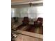 Sunroom with tiled floors, a ceiling fan, and large windows at 10731 W Mission Ln, Sun City, AZ 85351