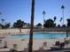 Relaxing community swimming pool with lounge chairs at 10731 W Mission Ln, Sun City, AZ 85351