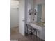 Ensuite vanity area with a marble countertop, chair, and storage at 10731 W Mission Ln, Sun City, AZ 85351