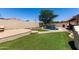 Backyard with lush green grass, a sparkling pool, and a paved patio, ideal for outdoor living at 11346 E Renata Ave, Mesa, AZ 85212