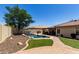 Well-maintained backyard with an in-ground pool, lush grass, and a paved patio at 11346 E Renata Ave, Mesa, AZ 85212