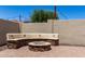 Inviting backyard features a cozy fire pit with a built-in bench, perfect for outdoor gatherings at 11346 E Renata Ave, Mesa, AZ 85212